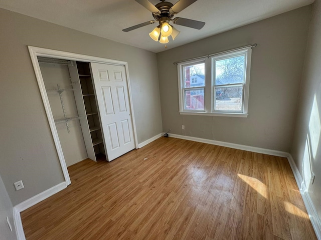 619 Palmer Pl, Des Moines, IA 50315 - unfurnished bedroom with light wood finished floors, baseboards, a closet, and ceiling fan