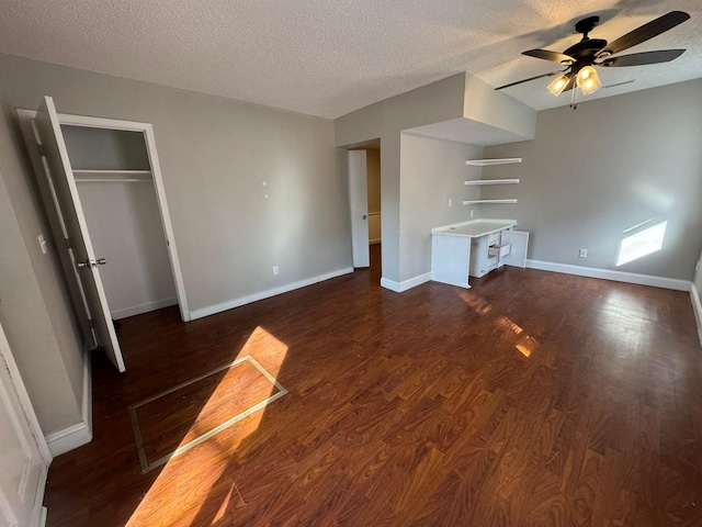 619 Palmer Pl, Des Moines, IA 50315 - unfurnished living room with ceiling fan, a textured ceiling, dark wood-style flooring, and baseboards