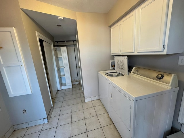 619 Palmer Pl, Des Moines, IA 50315 - laundry room featuring cabinet space, washer and dryer, light tile patterned flooring, and baseboards