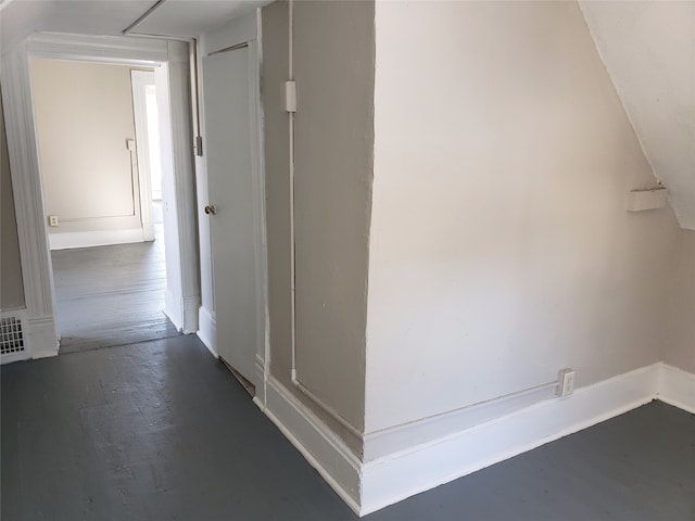 hallway with baseboards and wood finished floors