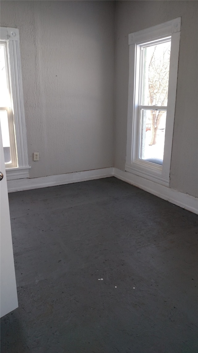 unfurnished room featuring baseboards