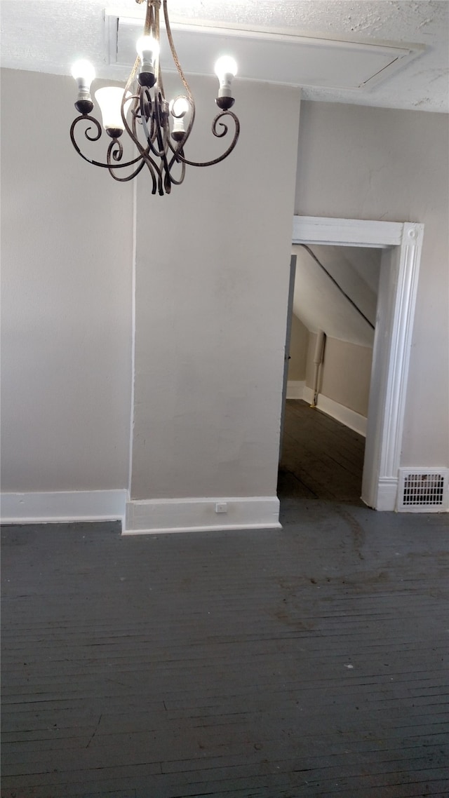 unfurnished dining area with a chandelier and baseboards