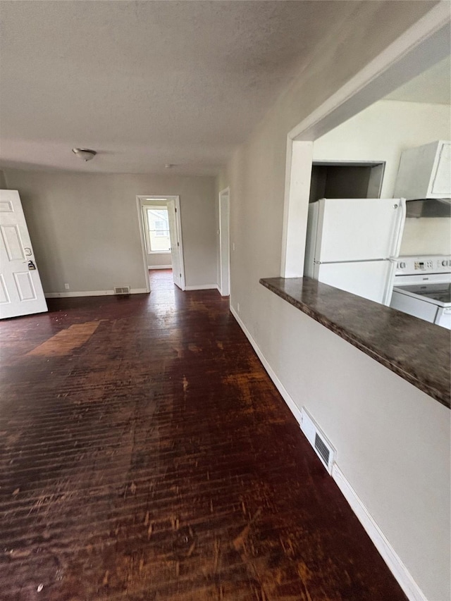 2810 Payne Rd, Des Moines, IA 50310 - corridor with wood finished floors, baseboards, and a textured ceiling