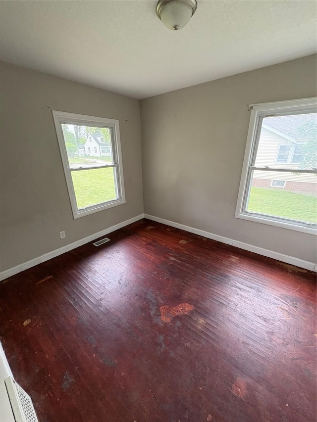 2810 Payne Rd, Des Moines, IA 50310 - unfurnished room with plenty of natural light, baseboards, and dark wood-style flooring