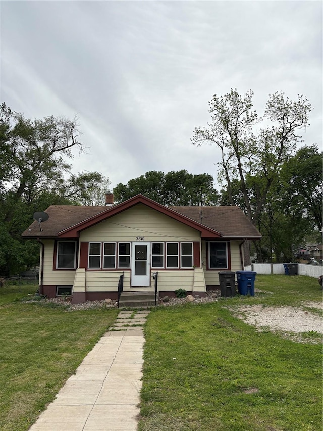 2810 Payne Rd, Des Moines, IA 50310 - view of front of home featuring a chimney, entry steps, and roof with shingles