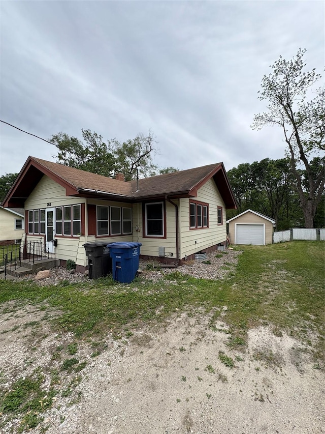 2810 Payne Rd, Des Moines, IA 50310 - view of front facade with an outdoor structure, a garage, fence, and a chimney