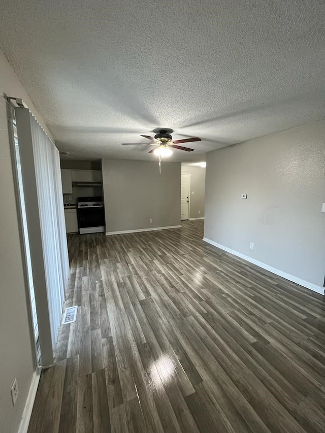 unfurnished living room with dark wood-style floors, ceiling fan, baseboards, and a textured ceiling
