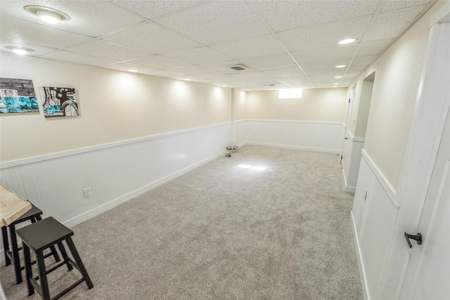 1916 Locust St, West Des Moines, IA 50265 - finished basement featuring a paneled ceiling, wainscoting, and carpet flooring