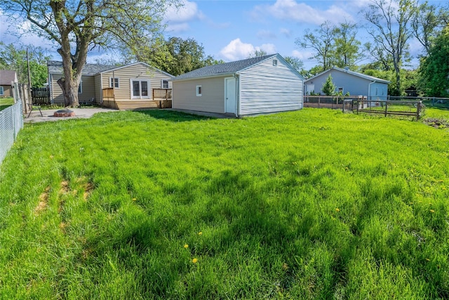 1916 Locust St, West Des Moines, IA 50265 - fenced backyard with a fire pit, an outbuilding, and a deck