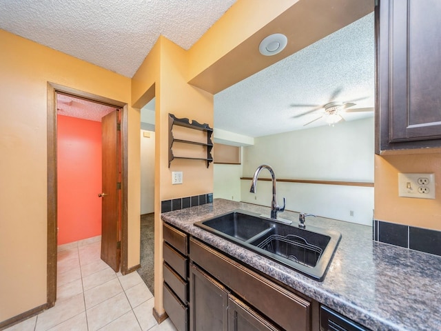 5200 Twana Dr, Des Moines, IA 50310 - kitchen with a textured ceiling, a sink, dark brown cabinetry, light tile patterned flooring, and ceiling fan