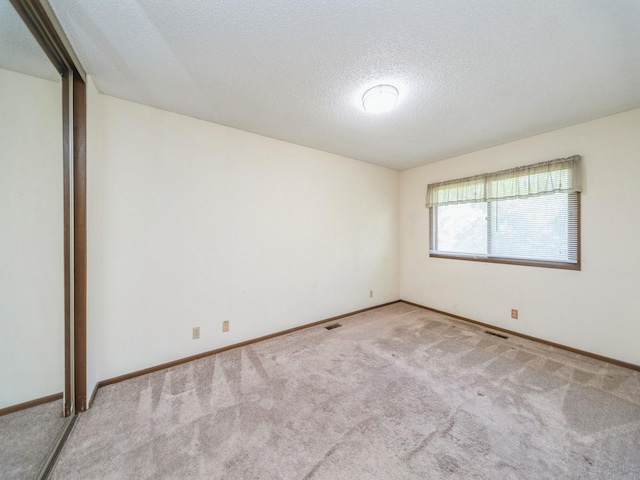 5200 Twana Dr, Des Moines, IA 50310 - unfurnished room with carpet flooring, a textured ceiling, and baseboards