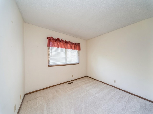 5200 Twana Dr, Des Moines, IA 50310 - empty room with carpet flooring, baseboards, and a textured ceiling