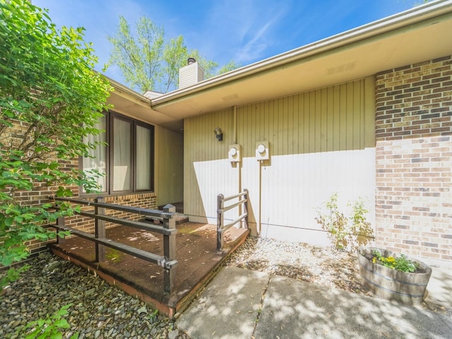 5200 Twana Dr, Des Moines, IA 50310 - doorway to property featuring a chimney and brick siding