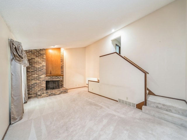 5200 Twana Dr, Des Moines, IA 50310 - unfurnished living room with stairway, carpet floors, a fireplace, recessed lighting, and baseboards