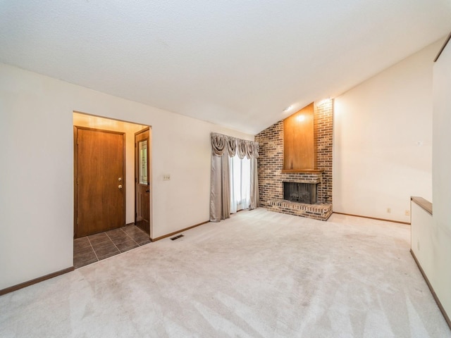 5200 Twana Dr, Des Moines, IA 50310 - unfurnished living room featuring lofted ceiling, carpet flooring, a fireplace, and baseboards