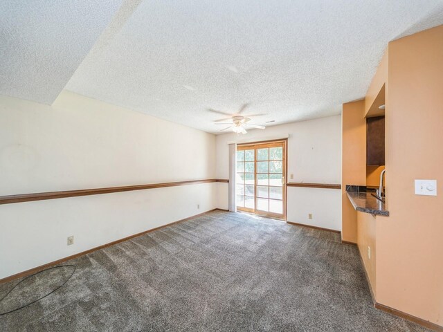 5200 Twana Dr, Des Moines, IA 50310 - carpeted empty room with a ceiling fan, a textured ceiling, and baseboards