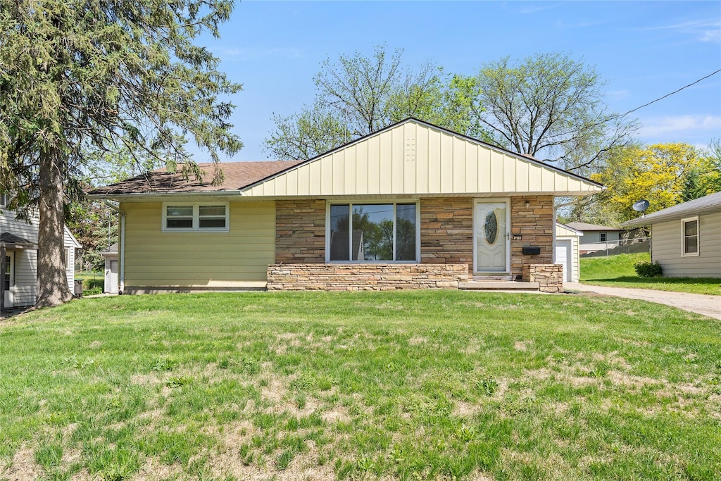 2616 Arthur Ave, Des Moines, IA 50317 - view of front of home with stone siding, a front lawn, and concrete driveway