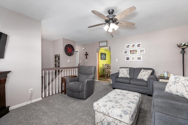living room featuring carpet flooring, ceiling fan, and baseboards