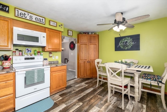 kitchen featuring white appliances, dark wood-style floors, and ceiling fan