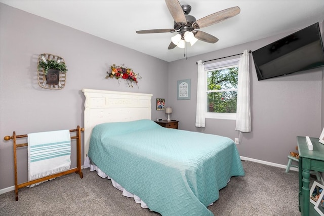 carpeted bedroom featuring baseboards and a ceiling fan