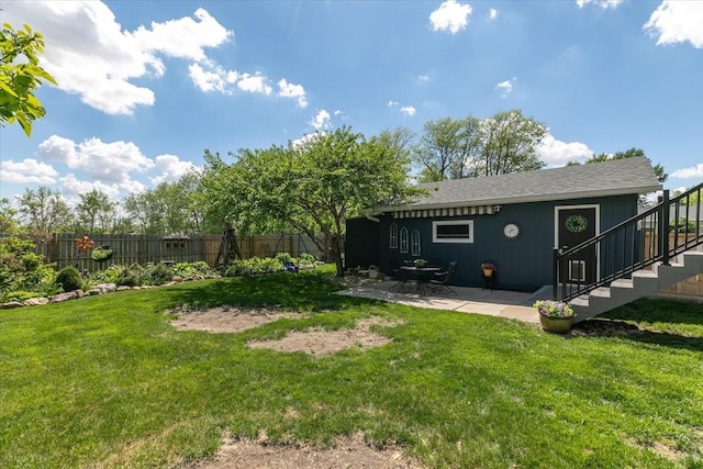view of yard featuring stairway and a patio