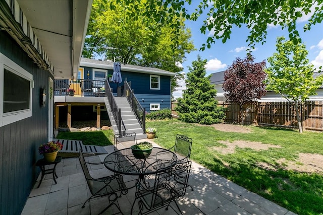 view of patio / terrace with stairway, outdoor dining area, and a deck