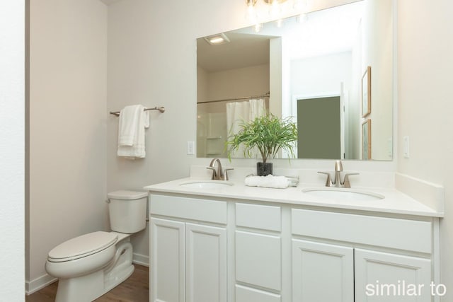 full bath with toilet, double vanity, wood finished floors, baseboards, and a shower with shower curtain