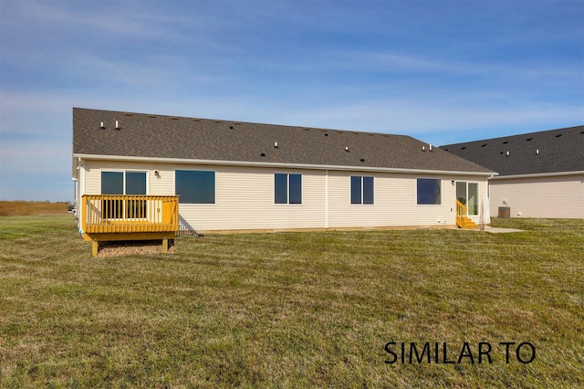 6565 NE 11th Ct, Des Moines, IA 50313 - rear view of property with a deck, a lawn, and roof with shingles