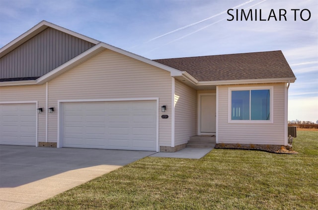 6565 NE 11th Ct, Des Moines, IA 50313 - view of front facade featuring a garage, driveway, a front lawn, and roof with shingles