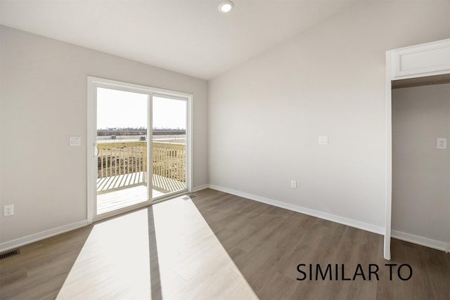 6565 NE 11th Ct, Des Moines, IA 50313 - empty room featuring wood finished floors, baseboards, lofted ceiling, and recessed lighting