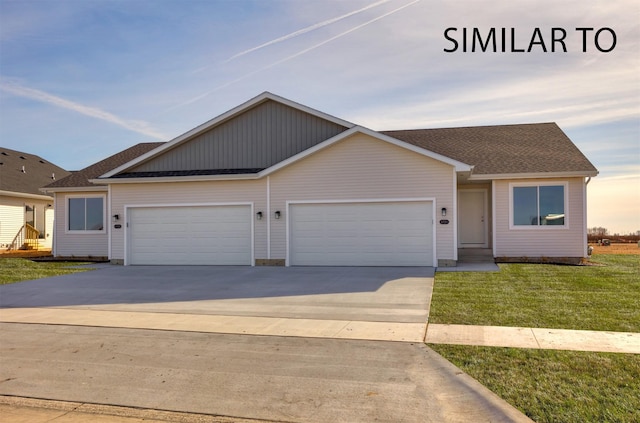 6557 NE 11th Ct, Des Moines, IA 50313 - view of front of house with an attached garage, concrete driveway, a front lawn, and roof with shingles