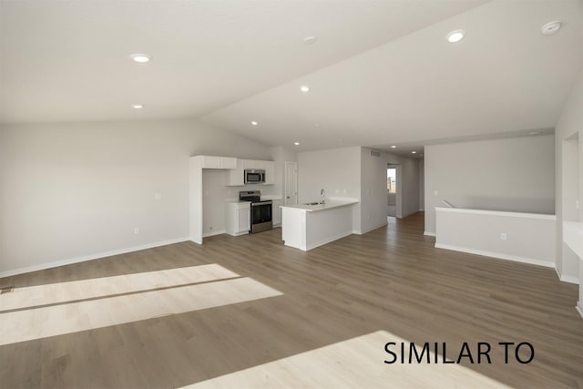 6557 NE 11th Ct, Des Moines, IA 50313 - unfurnished living room featuring light wood-type flooring, lofted ceiling, and recessed lighting