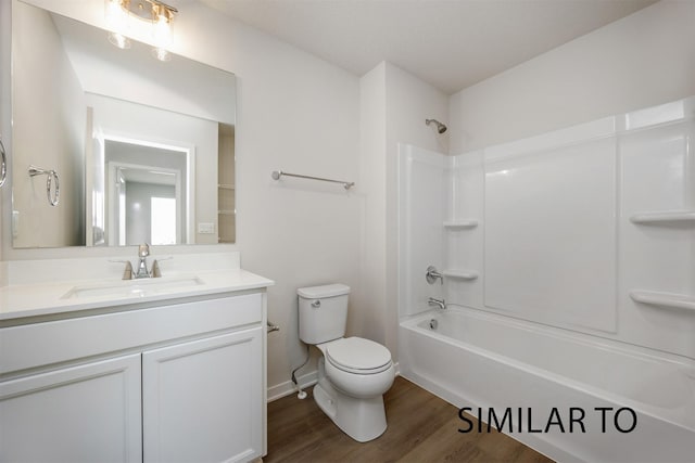 6557 NE 11th Ct, Des Moines, IA 50313 - full bathroom with wood finished floors, vanity, and washtub / shower combination
