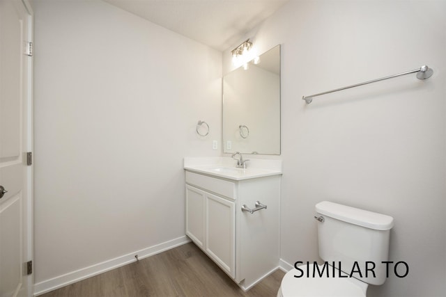 6557 NE 11th Ct, Des Moines, IA 50313 - half bathroom featuring vanity and wood finished floors