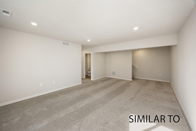 6557 NE 11th Ct, Des Moines, IA 50313 - finished basement featuring light carpet, recessed lighting, and stairs