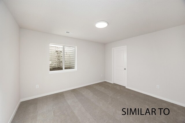 6557 NE 11th Ct, Des Moines, IA 50313 - carpeted empty room with baseboards
