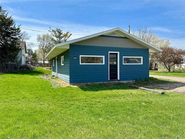 back of property featuring a yard