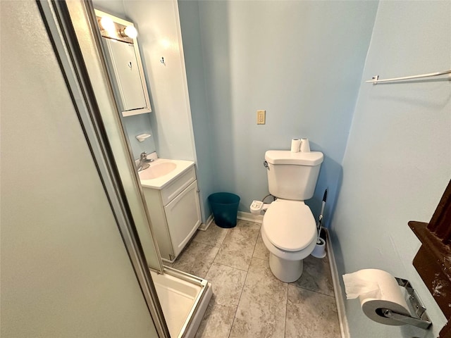 bathroom with toilet, vanity, tile patterned flooring, and a shower stall