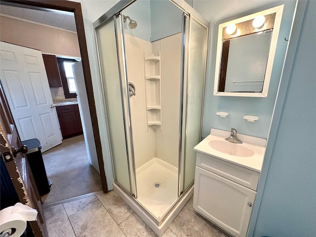 bathroom featuring a shower stall, vanity, and tile patterned flooring