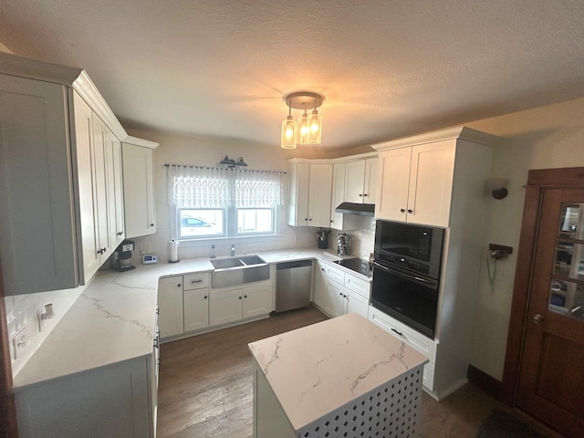 1913 N 1st St, Winterset, IA 50273 - kitchen with black appliances, a sink, wood finished floors, light stone countertops, and a chandelier
