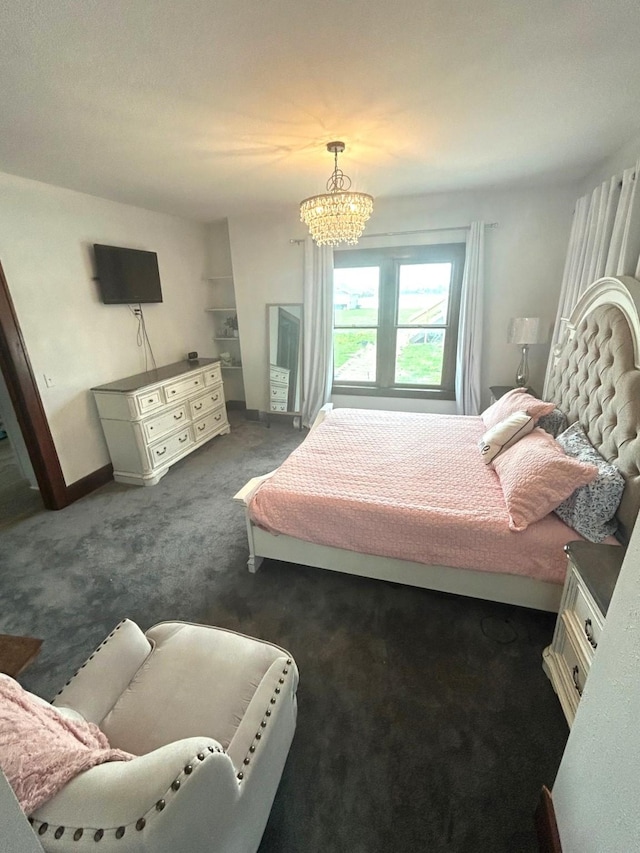 1913 N 1st St, Winterset, IA 50273 - bedroom with a chandelier, dark carpet, and baseboards