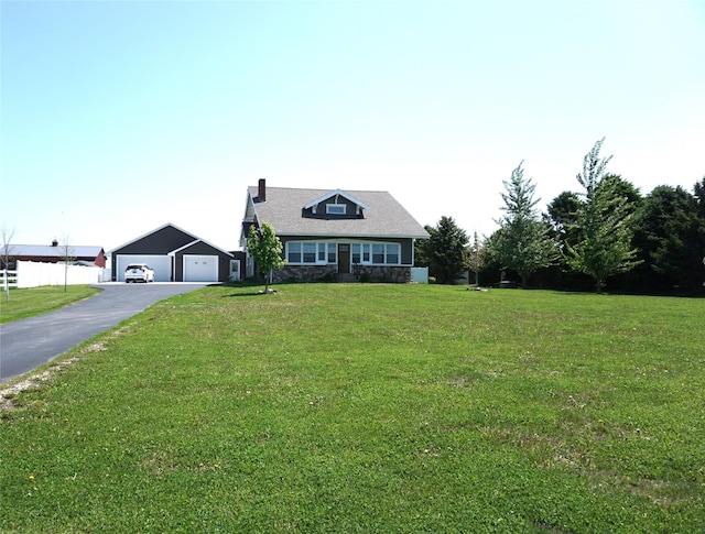 1913 N 1st St, Winterset, IA 50273 - view of front of property featuring a chimney, a front lawn, and a detached garage