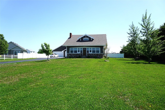 1913 N 1st St, Winterset, IA 50273 - view of front facade featuring a chimney, stone siding, and driveway