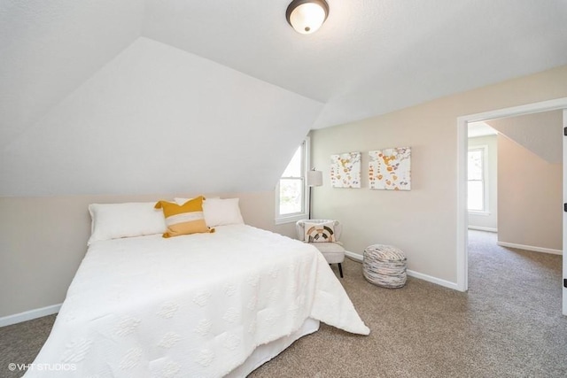 930 Forest Ave, Des Moines, IA 50314 - carpeted bedroom featuring vaulted ceiling and baseboards
