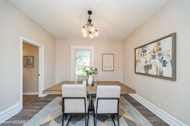 930 Forest Ave, Des Moines, IA 50314 - dining room featuring wood finished floors, a chandelier, and baseboards