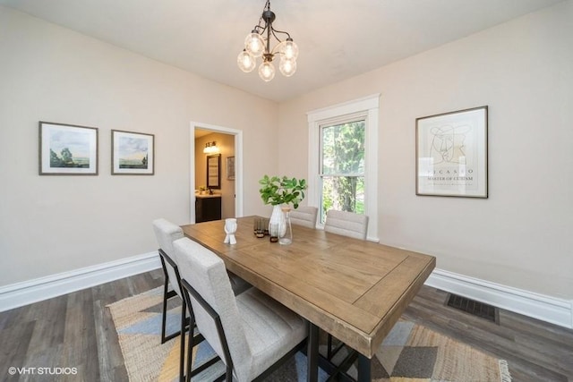 930 Forest Ave, Des Moines, IA 50314 - dining room with a chandelier, baseboards, and dark wood-type flooring