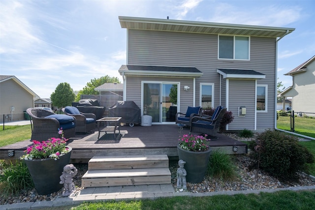 back of house with fence, a wooden deck, and an outdoor living space