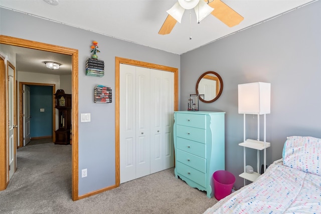 carpeted bedroom featuring a closet, a ceiling fan, and baseboards