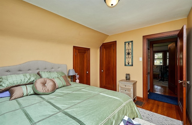 bedroom featuring wood finished floors and baseboards