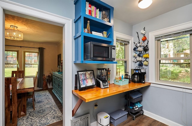 home office featuring dark wood-type flooring and baseboards